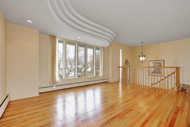 9 Ensign Dr, Massapequa, NY 11758 - empty room with baseboard heating, a notable chandelier, wood finished floors, and recessed lighting