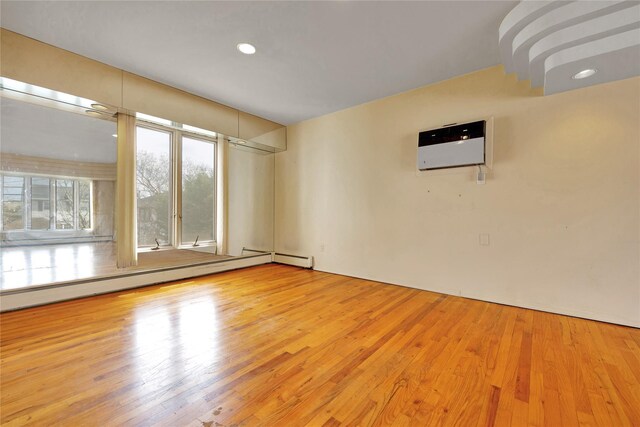 9 Ensign Dr, Massapequa, NY 11758 - spare room featuring baseboard heating and wood finished floors