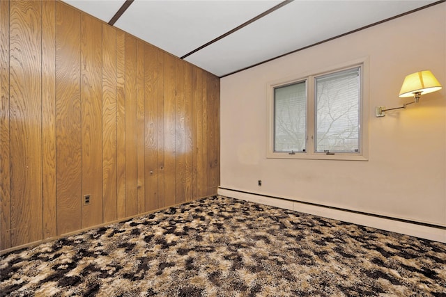 9 Ensign Dr, Massapequa, NY 11758 - empty room with a baseboard heating unit, carpet, and wood walls