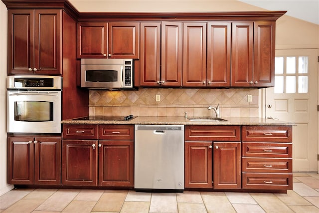 9 Ensign Dr, Massapequa, NY 11758 - kitchen with stainless steel appliances, a sink, light stone counters, and tasteful backsplash