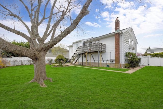 9 Ensign Dr, Massapequa, NY 11758 - rear view of property featuring a gate, stairway, fence, a yard, and a wooden deck