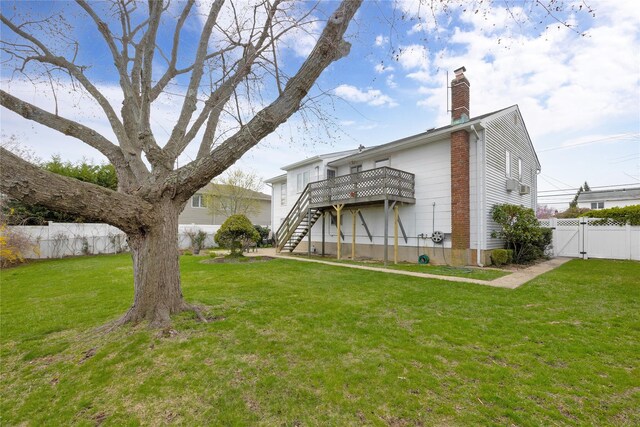 9 Ensign Dr, Massapequa, NY 11758 - rear view of property with a gate, stairs, fence, a lawn, and a deck