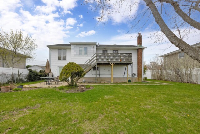 9 Ensign Dr, Massapequa, NY 11758 - rear view of house featuring a patio area, a chimney, fence, and a yard