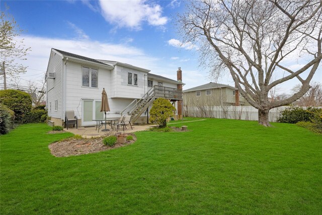 9 Ensign Dr, Massapequa, NY 11758 - rear view of house with a patio area, a lawn, stairs, and a deck