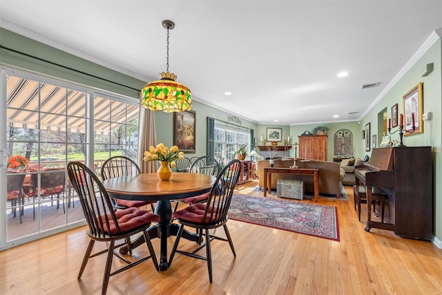 dining space with visible vents, crown molding, light wood finished floors, and recessed lighting