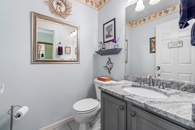 half bathroom featuring baseboards, toilet, tile patterned flooring, and vanity