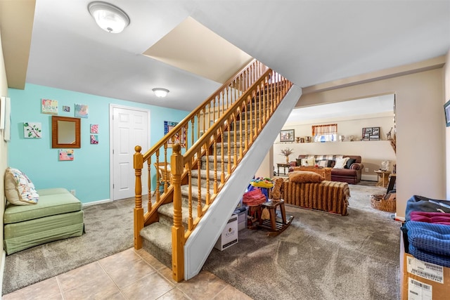 stairs featuring tile patterned flooring and carpet floors
