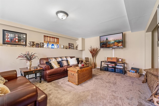 carpeted living area with baseboards