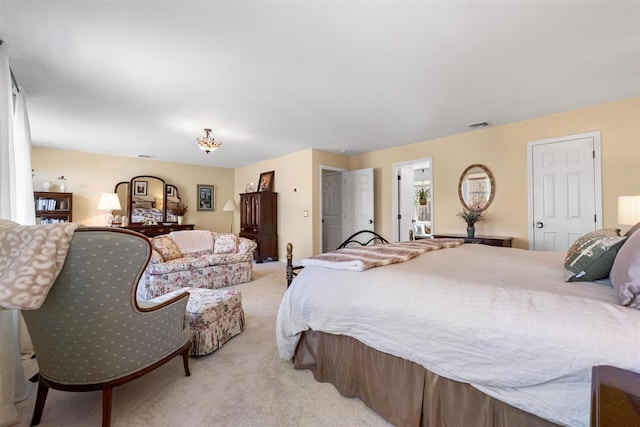 bedroom featuring visible vents and light carpet