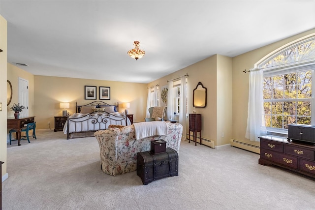 bedroom featuring a baseboard heating unit, visible vents, and light carpet