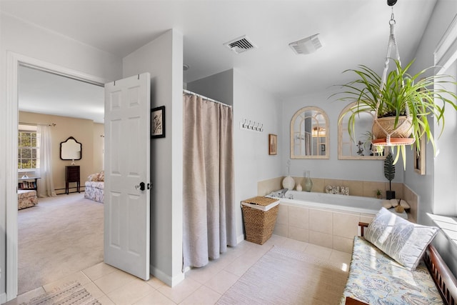ensuite bathroom featuring visible vents, baseboards, tile patterned floors, and ensuite bath