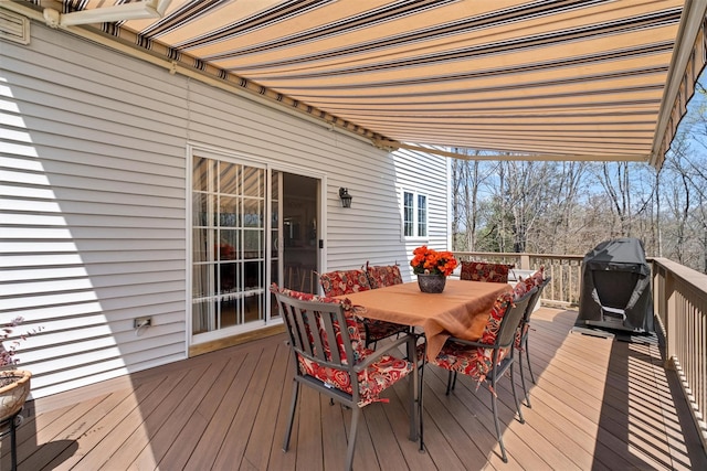 wooden deck featuring area for grilling and outdoor dining space