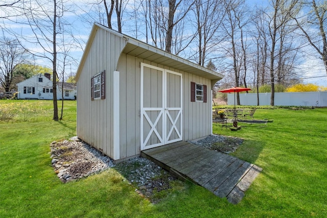 view of shed featuring fence