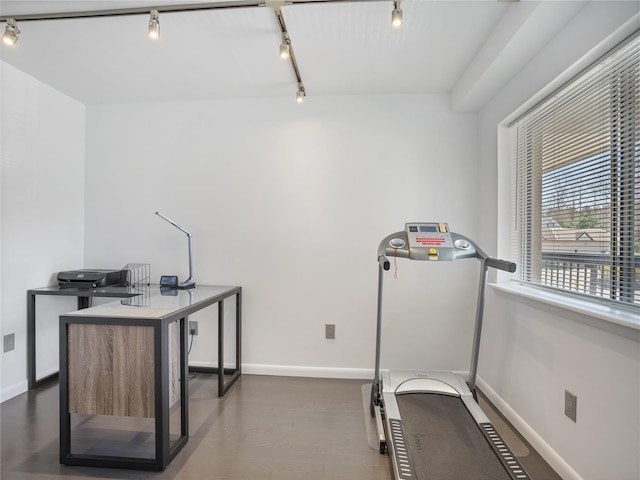 workout area with track lighting, wood finished floors, and baseboards