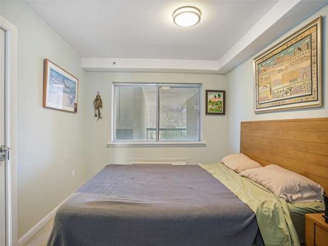carpeted bedroom featuring baseboards