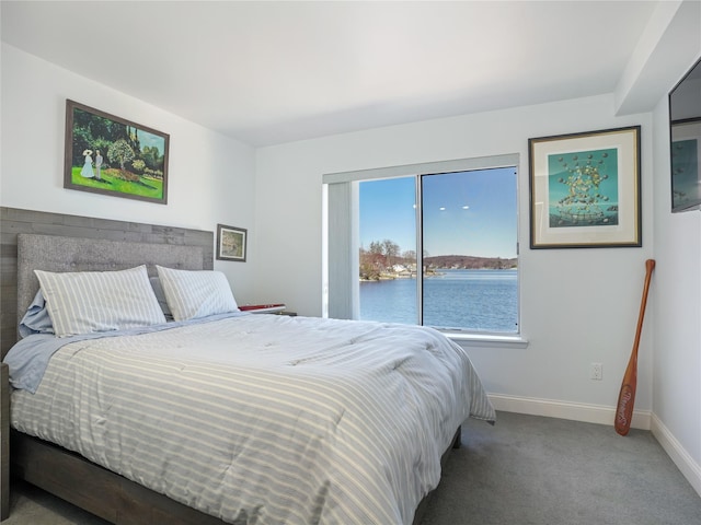 bedroom featuring baseboards and carpet flooring