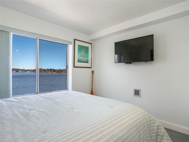 carpeted bedroom featuring baseboards and visible vents