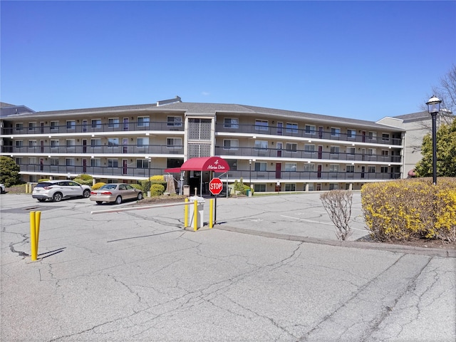 view of building exterior featuring uncovered parking