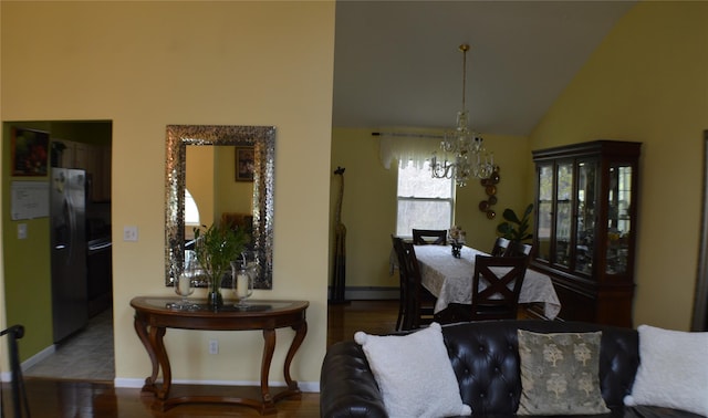 dining space featuring high vaulted ceiling, a baseboard radiator, wood finished floors, baseboards, and a notable chandelier