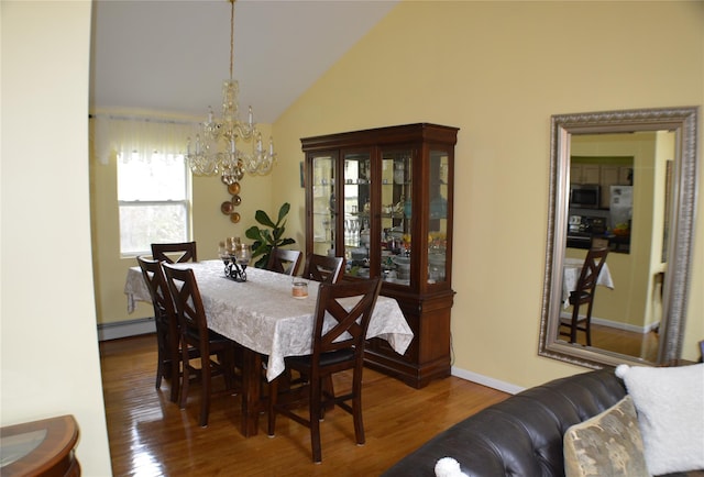 dining area featuring a baseboard heating unit, vaulted ceiling, wood finished floors, and an inviting chandelier