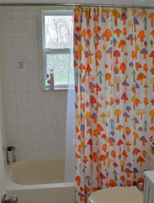 full bathroom featuring shower / bath combo and toilet