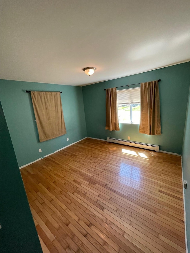 1137 Namdac Ave, Bay Shore, NY 11706 - unfurnished room with a baseboard heating unit and wood-type flooring