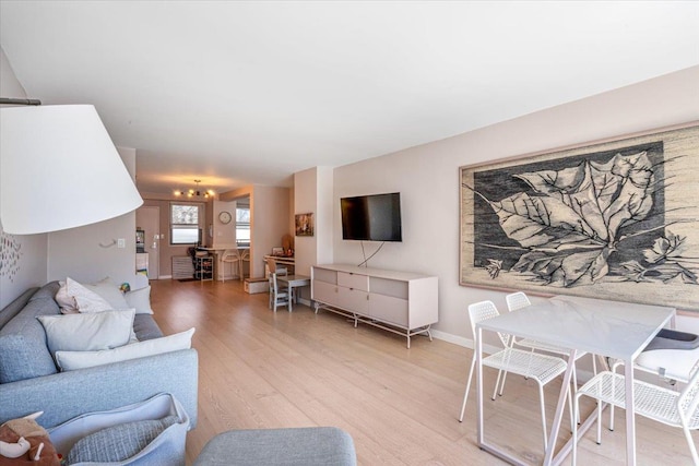 220-55 46th Ave Unit 3U, Bayside, NY 11361 - living room with a chandelier, light wood-style floors, and baseboards