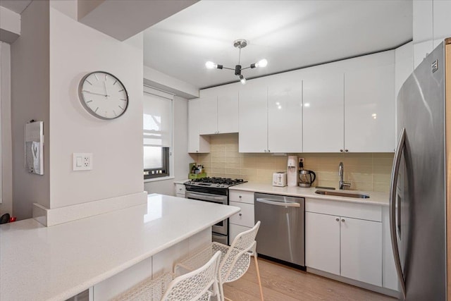 220-55 46th Ave Unit 3U, Bayside, NY 11361 - kitchen with light countertops, appliances with stainless steel finishes, decorative backsplash, and a sink