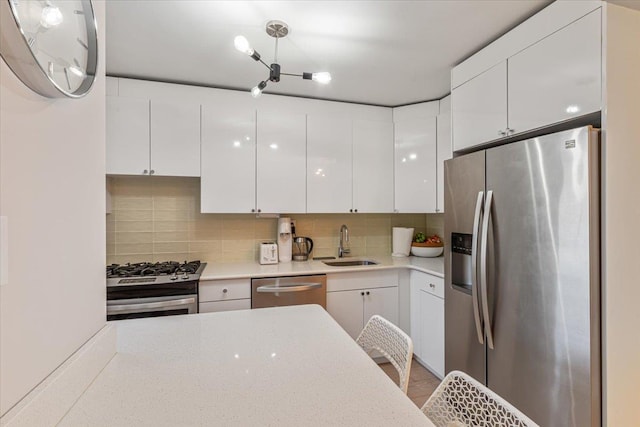 220-55 46th Ave Unit 3U, Bayside, NY 11361 - kitchen with light countertops, backsplash, white cabinets, appliances with stainless steel finishes, and a sink