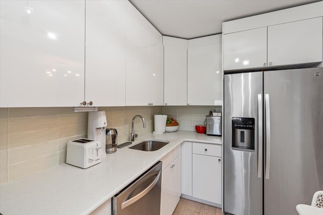 220-55 46th Ave Unit 3U, Bayside, NY 11361 - kitchen with a sink, backsplash, appliances with stainless steel finishes, and white cabinetry