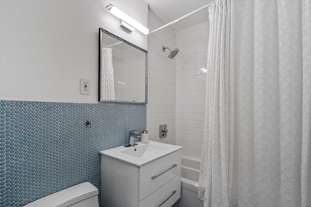 220-55 46th Ave Unit 3U, Bayside, NY 11361 - full bathroom with vanity, a wainscoted wall, toilet, shower / tub combo with curtain, and tile walls