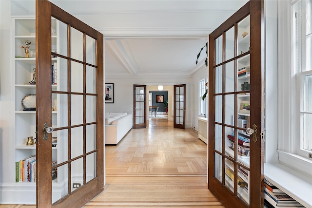 corridor featuring french doors, baseboards, crown molding, and beam ceiling