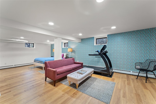 interior space featuring recessed lighting, baseboard heating, an accent wall, and wood finished floors