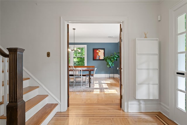 41 Euclid Ave, Hastings-On-Hudson, NY 10706 - corridor featuring ornamental molding, stairs, a chandelier, and baseboards