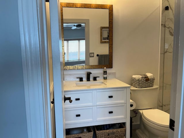 bathroom with toilet, ceiling fan, and vanity