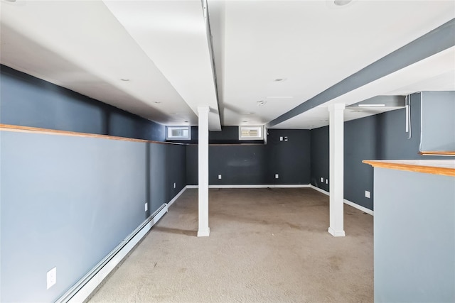 below grade area featuring a baseboard heating unit, baseboards, and carpet floors