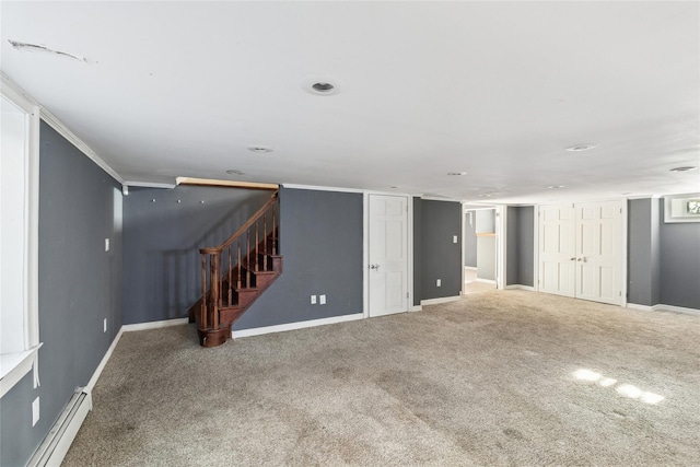 finished basement featuring carpet floors, baseboards, a baseboard heating unit, and stairs
