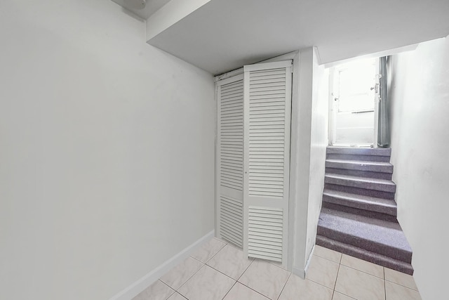 3205 Lafayette Ave, Bronx, NY 10465 - hallway with light tile patterned floors, baseboards, and stairway