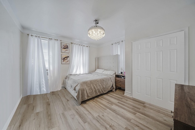 3205 Lafayette Ave, Bronx, NY 10465 - bedroom with light wood finished floors, baseboards, and an inviting chandelier