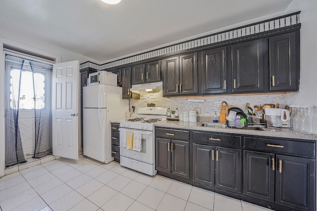 3205 Lafayette Ave, Bronx, NY 10465 - kitchen with white appliances, light countertops, light tile patterned flooring, under cabinet range hood, and a sink