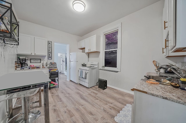 3205 Lafayette Ave, Bronx, NY 10465 - kitchen featuring baseboards, light countertops, white appliances, white cabinetry, and light wood finished floors