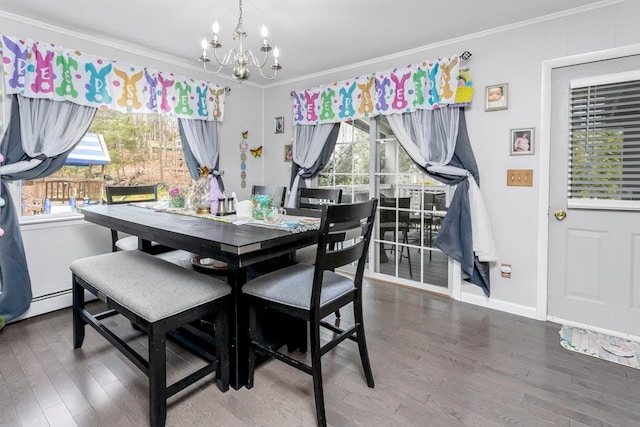 dining space with crown molding, wood finished floors, a notable chandelier, and baseboards