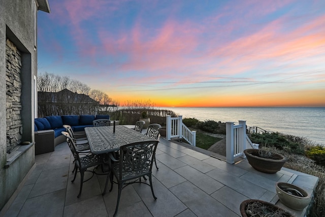 54985 Cr48, Southold, NY 11971 - patio terrace at dusk featuring a water view and outdoor dining space