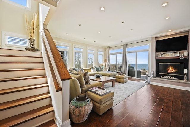 54985 Cr48, Southold, NY 11971 - living room with a glass covered fireplace, ornamental molding, recessed lighting, stairway, and dark wood finished floors