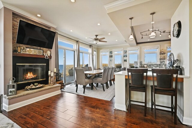54985 Cr48, Southold, NY 11971 - dining space featuring crown molding, a fireplace, and hardwood / wood-style flooring