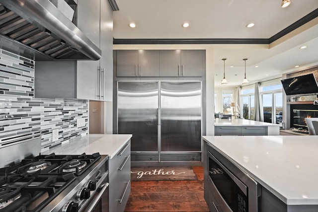 54985 Cr48, Southold, NY 11971 - kitchen with tasteful backsplash, ventilation hood, built in appliances, gray cabinetry, and dark wood-style floors