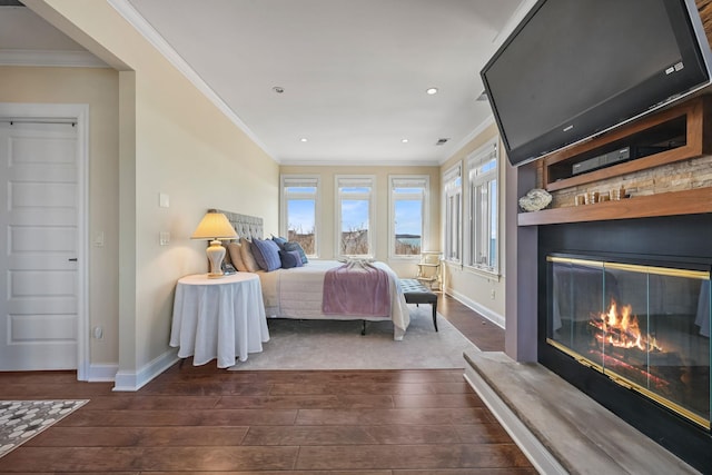54985 Cr48, Southold, NY 11971 - bedroom featuring dark wood-type flooring, crown molding, baseboards, and a glass covered fireplace