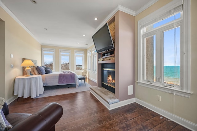 54985 Cr48, Southold, NY 11971 - bedroom with ornamental molding, baseboards, a glass covered fireplace, and dark wood-style floors