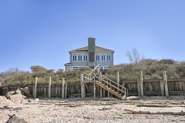 54985 Cr48, Southold, NY 11971 - back of property with stairs, fence, and a chimney