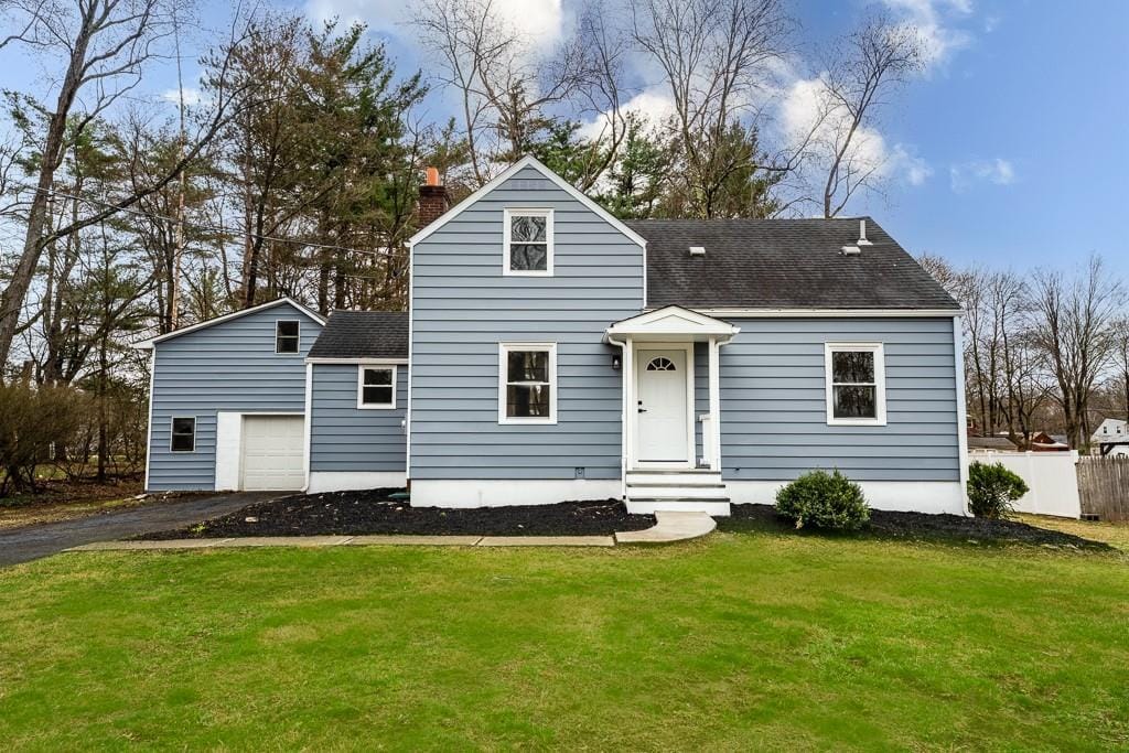 292 Spackenkill Rd, Poughkeepsie, NY 12603 - view of front of property featuring fence, a front lawn, a chimney, a shingled roof, and driveway